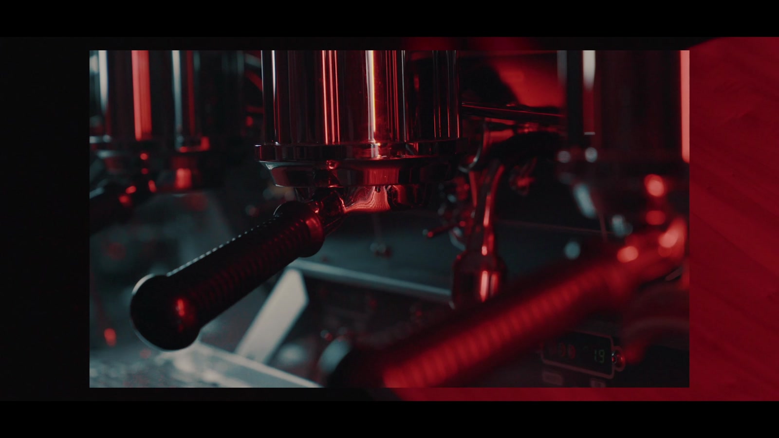Caturra espresso machine in a red-lit setting